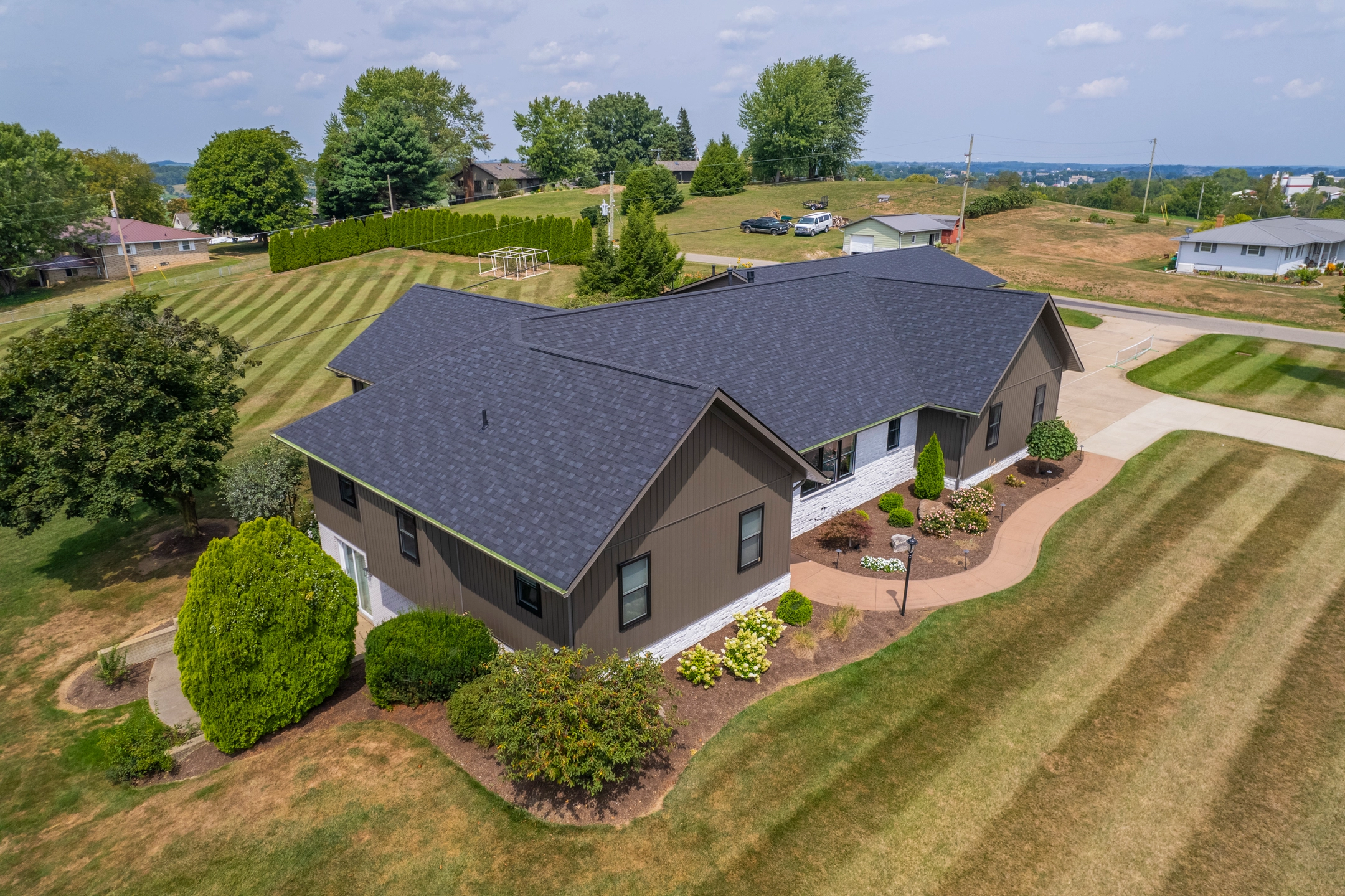 modern brown asphalt roofing house aerial view