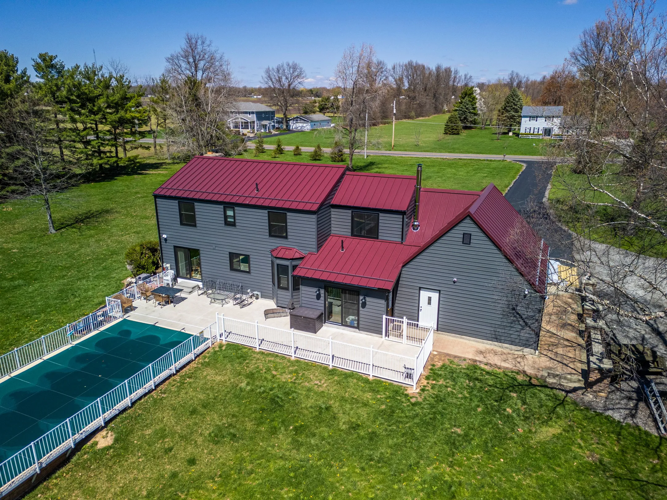 modern gray house with metal roof and pool