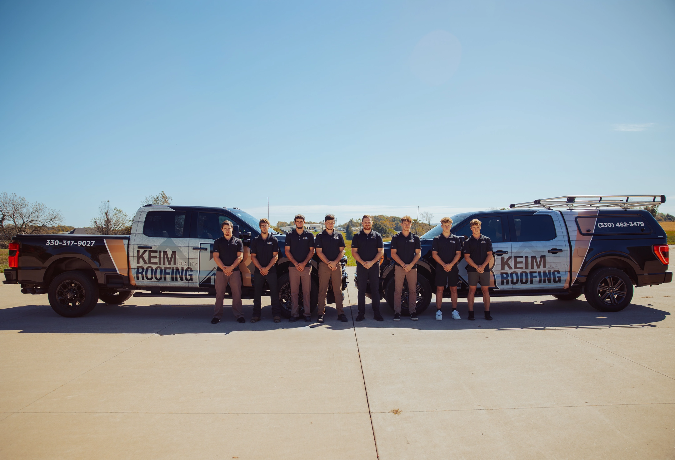 keim quality team standing outdoors with trucks