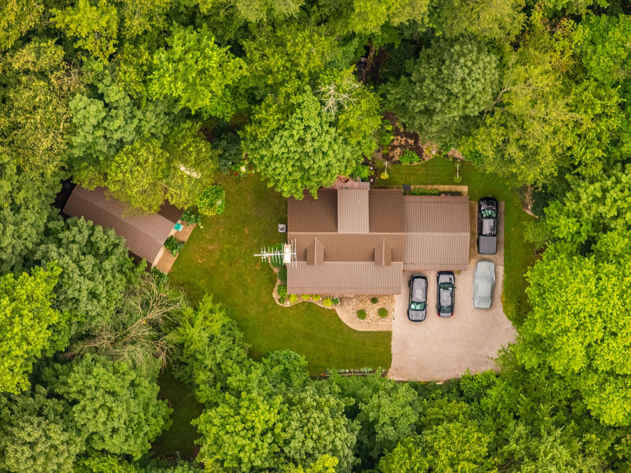 residential metal roofing house surrounded by forest