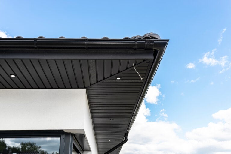 A modern graphite herringbone roof lining is attached to the trusses, visible turned on LED lights.