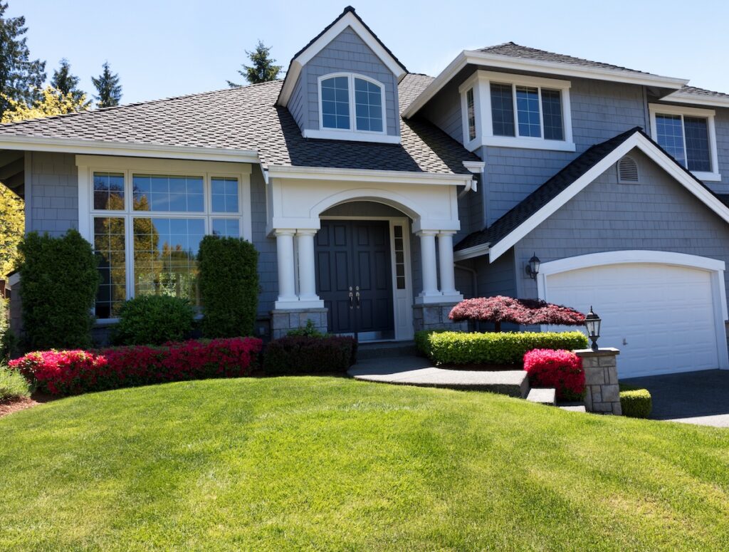 Front view of a well maintained front yard of home during a nice spring day