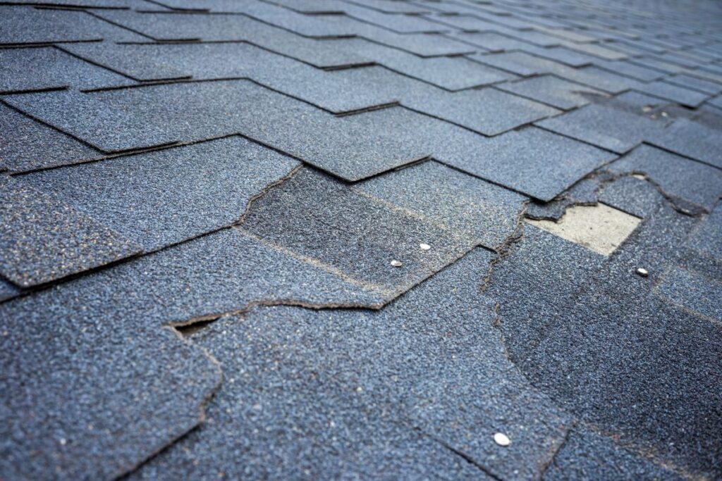 curling shingles roof damage Close up view