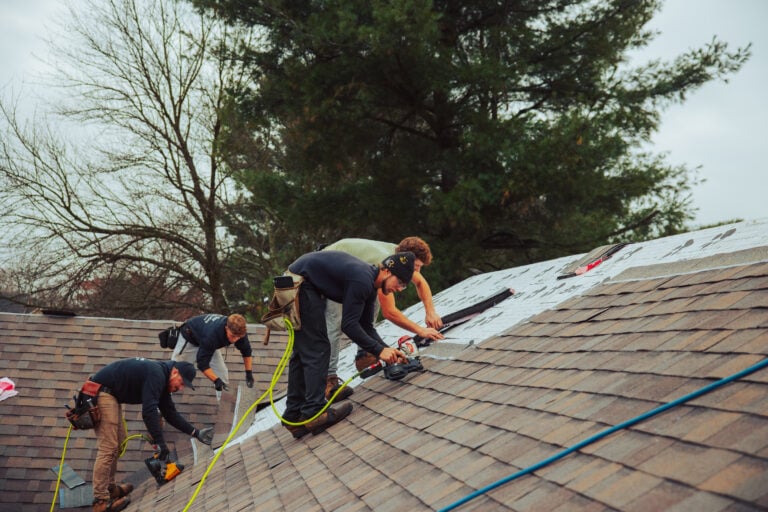 does home insurance cover roof repair Keim workers repairing shingles