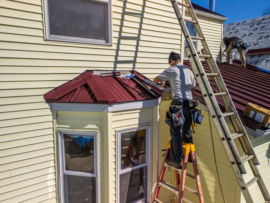 gaf timbersteel red metallic roof light yellow siding