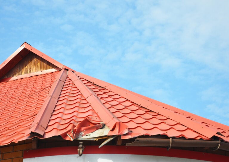 metal roof repair Close up on Broken Metal Roof and Rain Gutter. Damaged Roof.