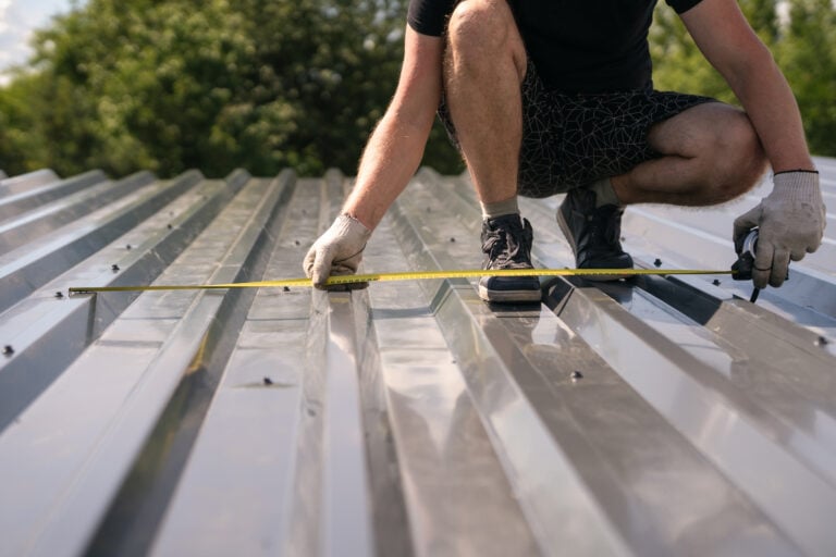 how to measure a roof for metal roofing The builder measures the width of the corrugated sheet on the roof with a tape measure