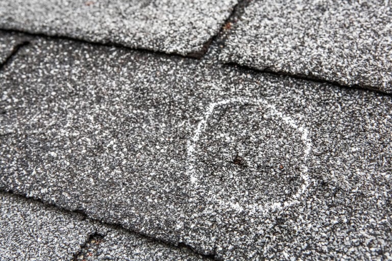 what does hail damage look like on a roof shingle with a hole after storm