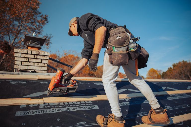 guy installing wooden roof part